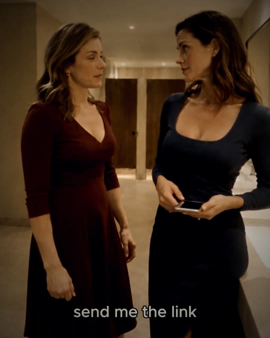 The two friends face each other, phone in hand